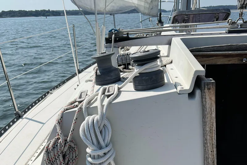 Slide: The Image of 1983 C&C 35 MKIII sailboat deck with winches and ropes on a sunny day. - 28