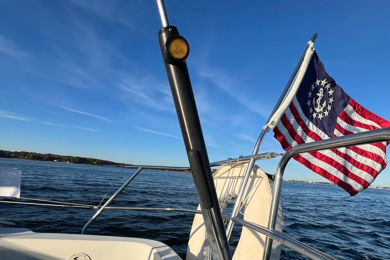 Slide: The Image of Sailing on a 1983 C&C 35 MKIII with a historic American flag in view. - 31