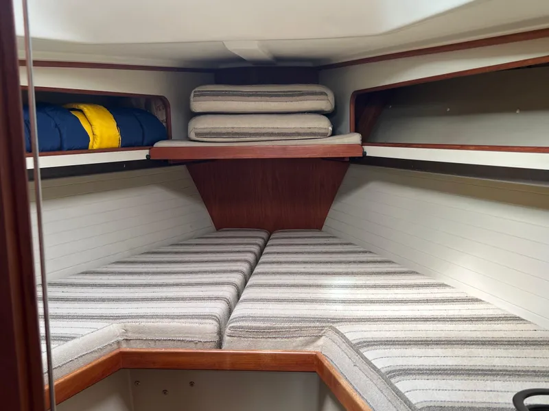 Slide: The Image of Interior cabin of 1983 C&C 35 MKIII sailboat with striped cushions and storage. - 35