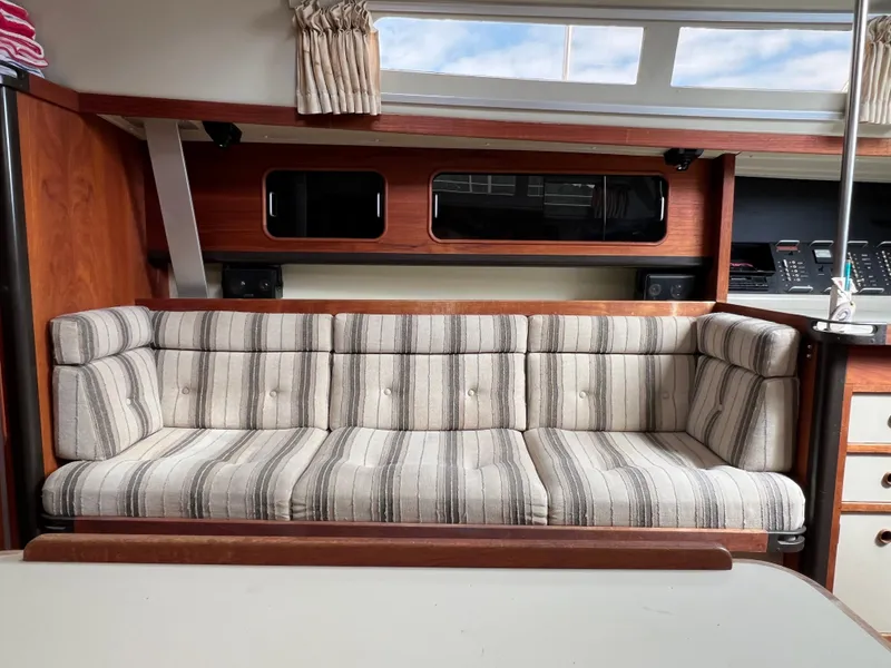Slide: The Image of Interior of 1983 C&C 35 MKIII sailboat with striped cushioned seating. - 41