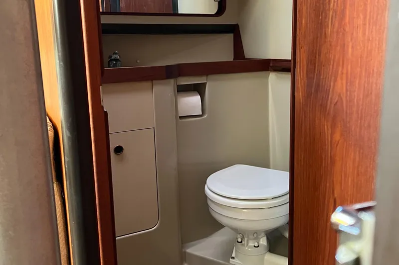 Slide: The Image of 1983 C&C 35 MKIII yacht bathroom with wooden accents and compact design. - 43