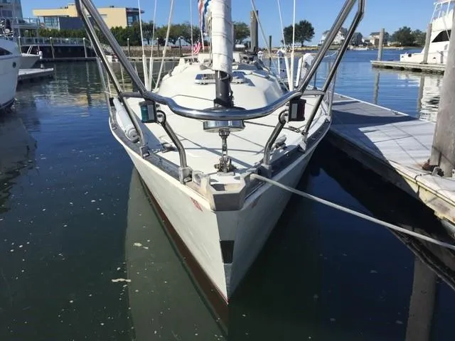 Slide: The Image of 1983 C&C 35 MKIII sailboat docked in a marina, front view. - 44
