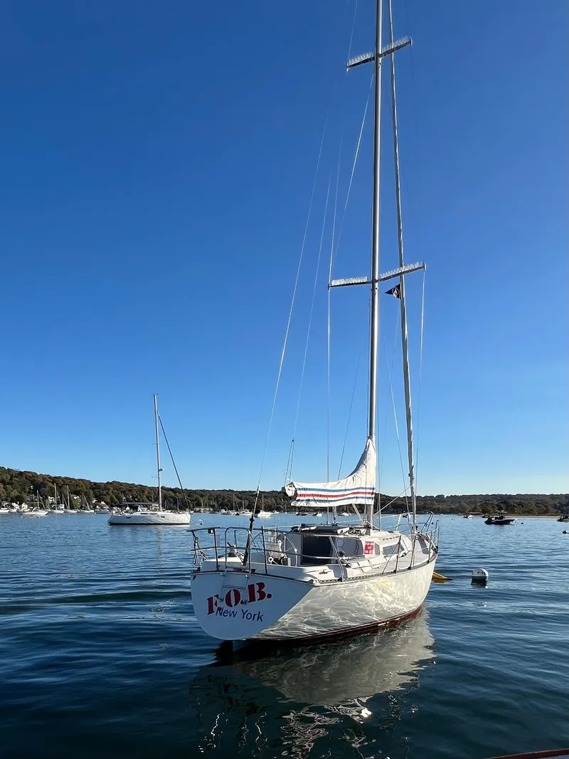 Slide: The Image of 1983 C&C 35 MKIII sailboat on calm water under clear blue sky. - 9