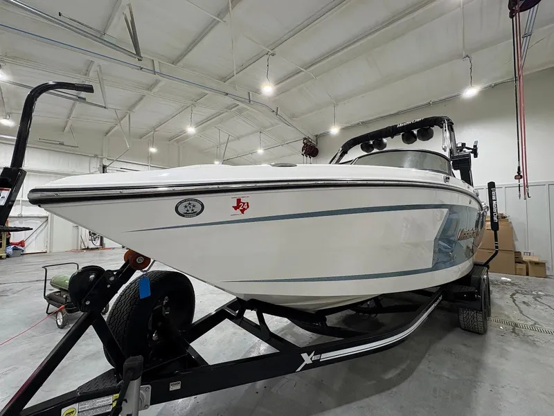 Slide: The Image of 2022 MasterCraft XStar S boat on trailer in indoor storage facility. - 3
