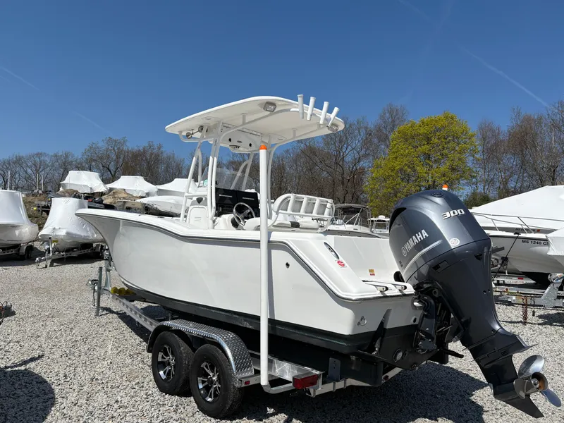 Slide: The Image of 2013 Tidewater 230 boat with Yamaha 300 engine on trailer, parked outdoors. - 8