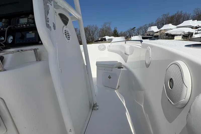 Slide: The Image of 2013 Tidewater 230 boat interior with speakers and storage compartments. - 14