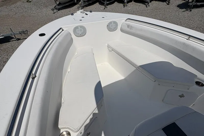 Slide: The Image of 2013 Tidewater 230 boat interior with white seating and speakers. - 15