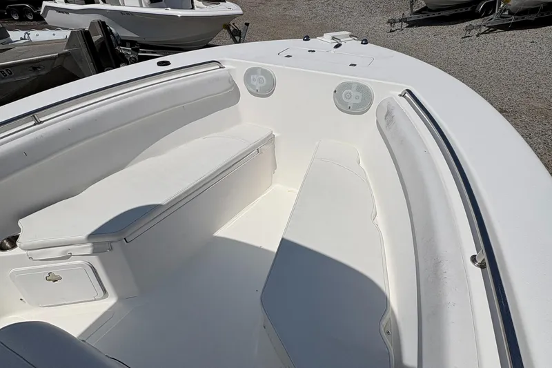 Slide: The Image of 2013 Tidewater 230 boat interior with white seating and storage compartments. - 16