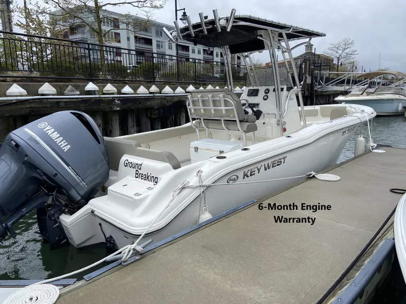 Slide: The Image of 2022 Key West 239 FS boat docked, featuring Yamaha engine and 6-month warranty. - 0