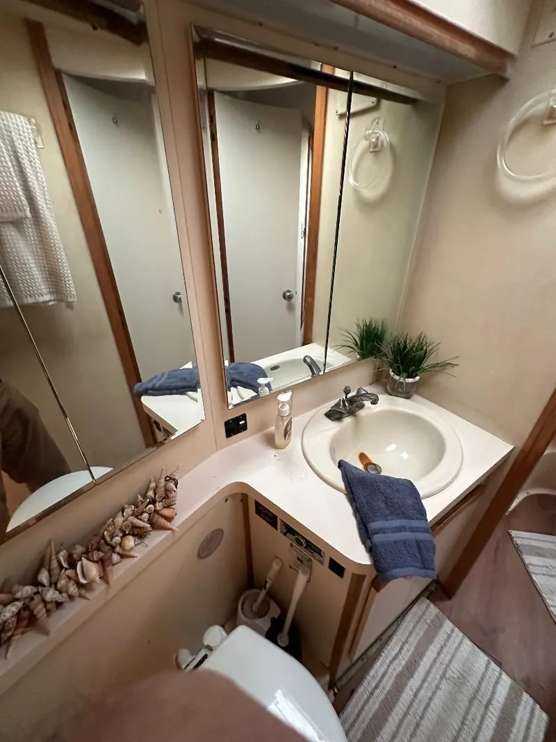 Slide: The Image of Bathroom interior of a 1989 Bertram 43 Convertible yacht with sink and mirror. - 11