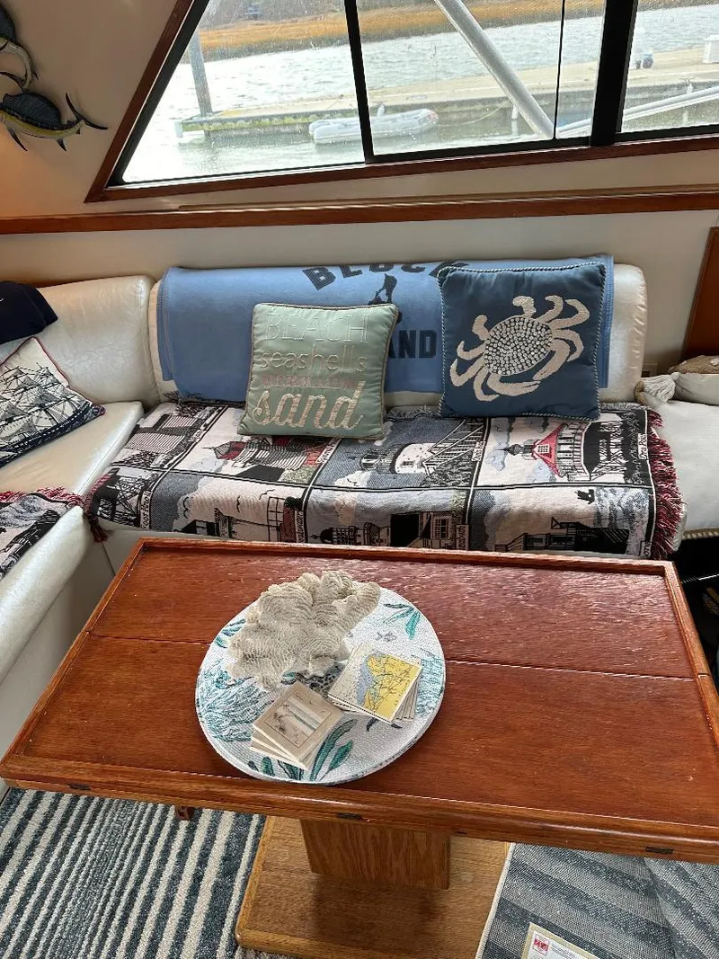Slide: The Image of Interior of a 1989 Bertram 43 Convertible yacht with cozy seating and nautical decor. - 22