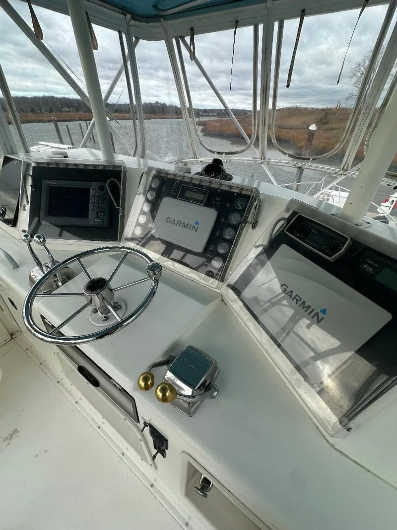 Slide: The Image of 1989 Bertram 43 Convertible helm with Garmin navigation displays and steering wheel. - 23