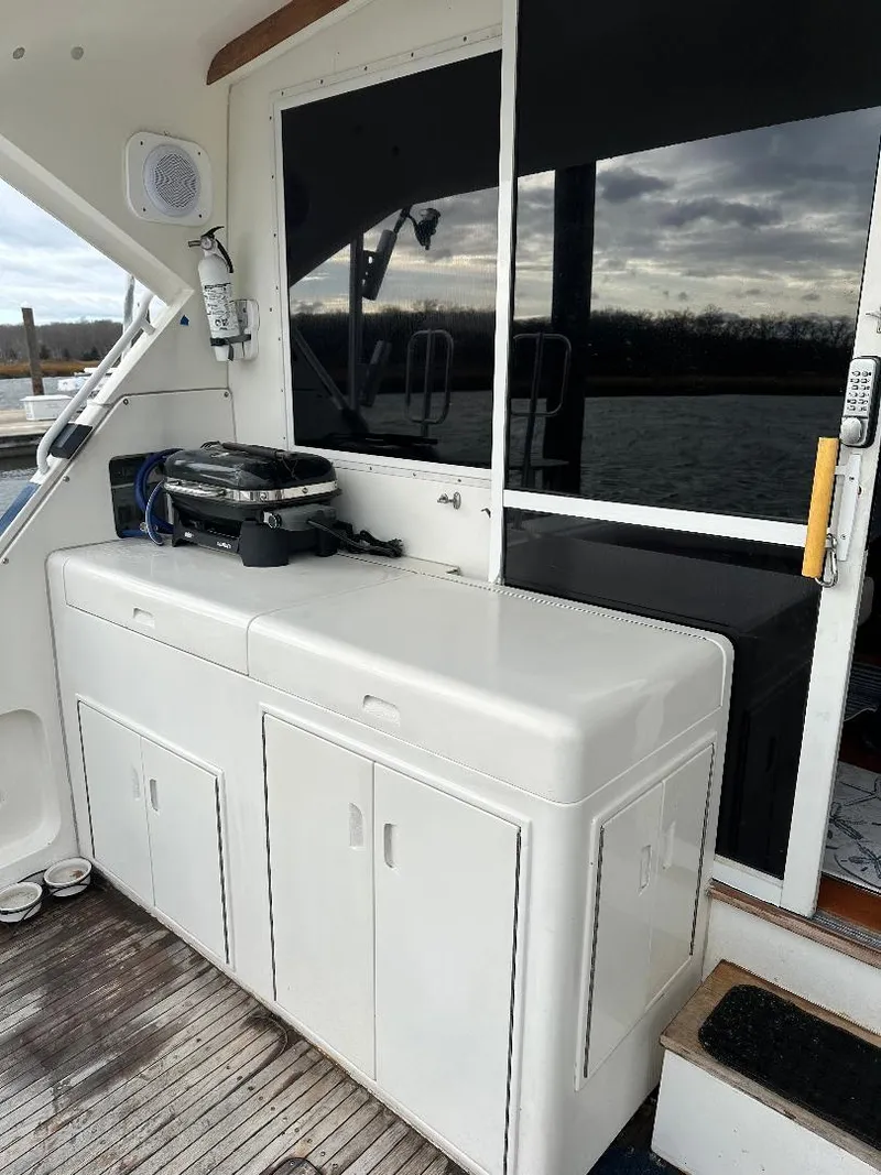 Slide: The Image of 1989 Bertram 43 Convertible yacht with outdoor kitchen and grill on deck. - 26