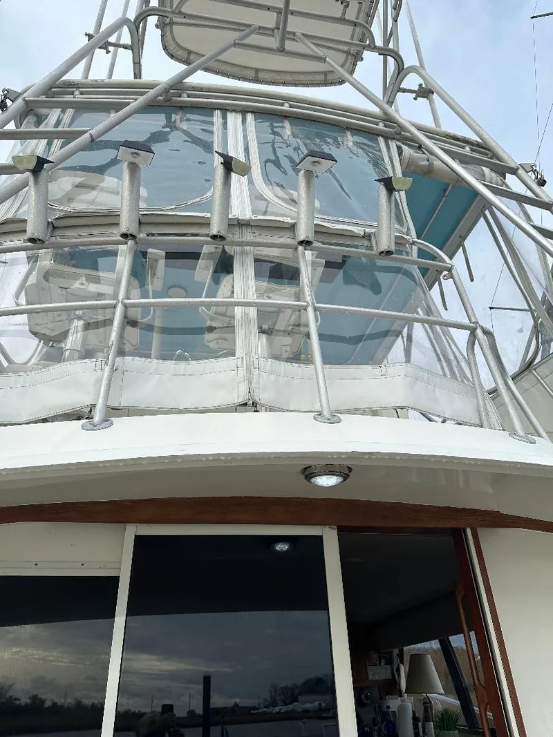 Slide: The Image of 1989 Bertram 43 Convertible yacht with upper deck and railing details. - 28