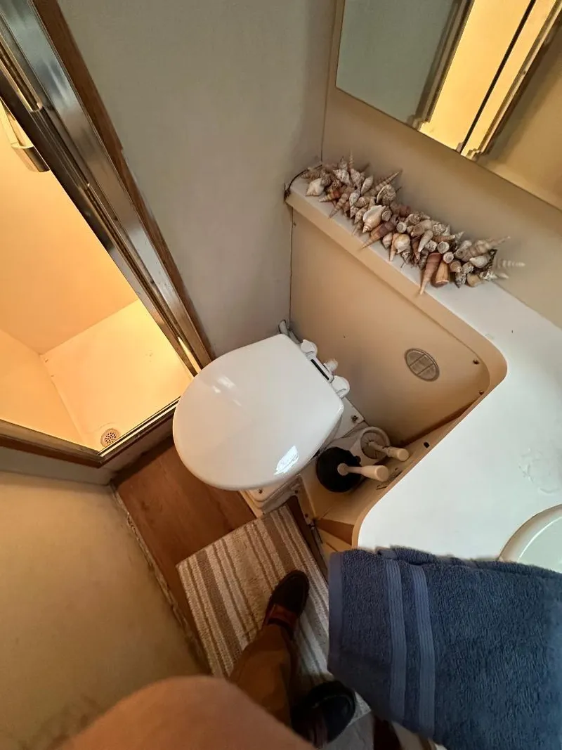 Slide: The Image of Bathroom interior of a 1989 Bertram 43 Convertible yacht with shower and decor. - 5