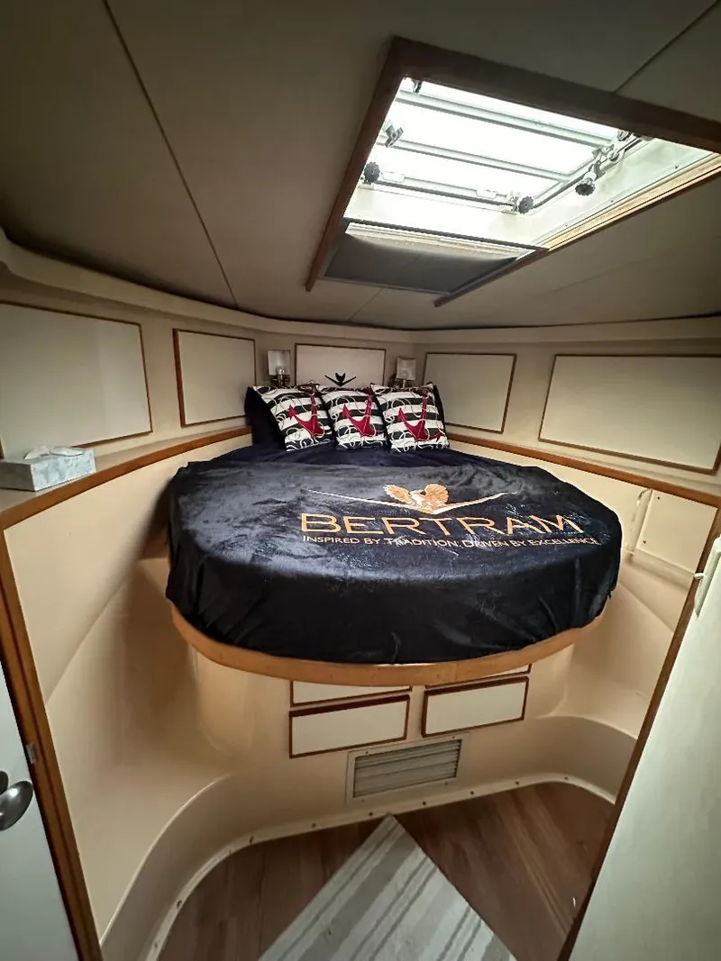 Slide: The Image of 1989 Bertram 43 Convertible cabin interior with bed and skylight. - 6