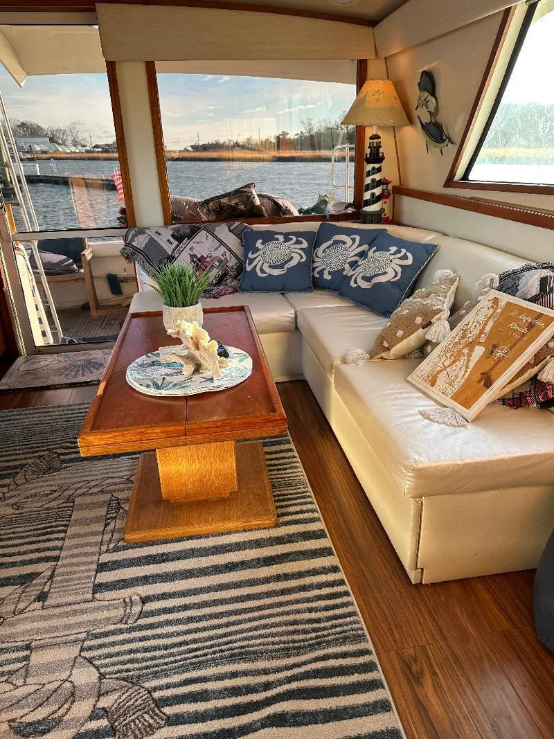 Slide: The Image of Interior of a 1989 Bertram 43 Convertible yacht with cozy seating and nautical decor. - 7