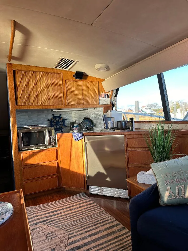 Slide: The Image of Interior of a 1989 Bertram 43 Convertible yacht with modern kitchen amenities. - 9