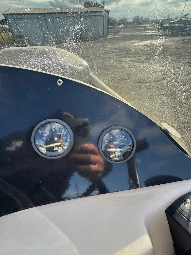 Slide: The Image of 2021 Aloha Pontoon Tropical Series boat interior with spacious seating in a garage setting. - 10