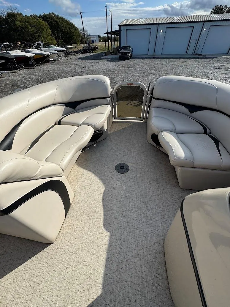 Slide: The Image of Interior of 2021 Aloha Pontoon Tropical Series with beige seating and spacious layout. - 11