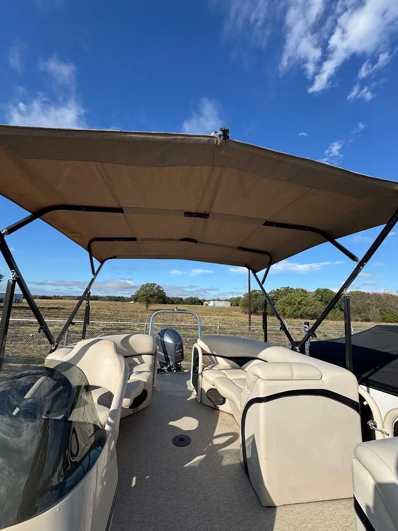 Slide: The Image of Steering console of 2021 Aloha Pontoon Tropical Series boat with gauges and controls. - 12