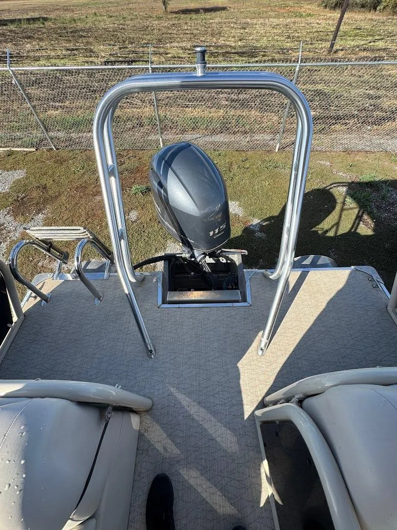 Slide: The Image of 2021 Aloha Pontoon Tropical Series with Yamaha 115 engine in a boat storage facility. - 13