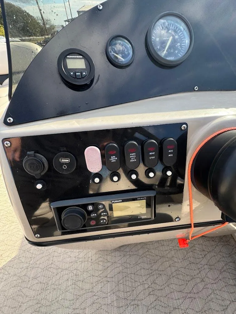 Slide: The Image of 2021 Aloha Pontoon Tropical Series with spacious seating and canopy in a garage setting. - 8