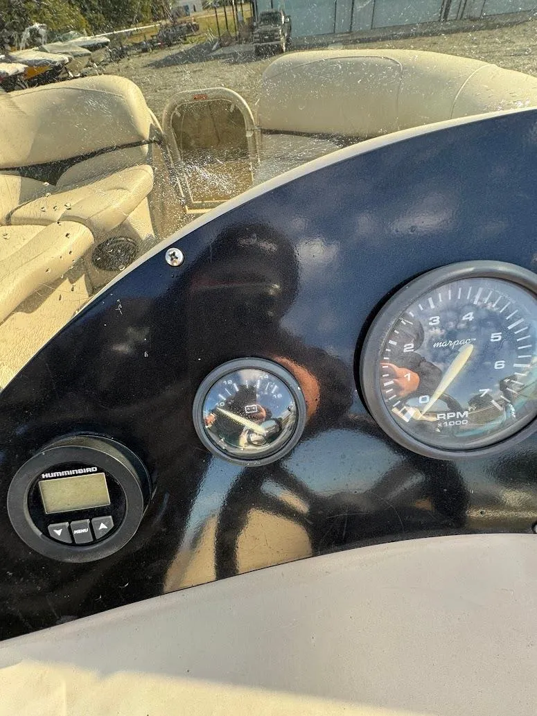 Slide: The Image of Interior of 2021 Aloha Pontoon Tropical Series boat with spacious seating and steering console. - 9