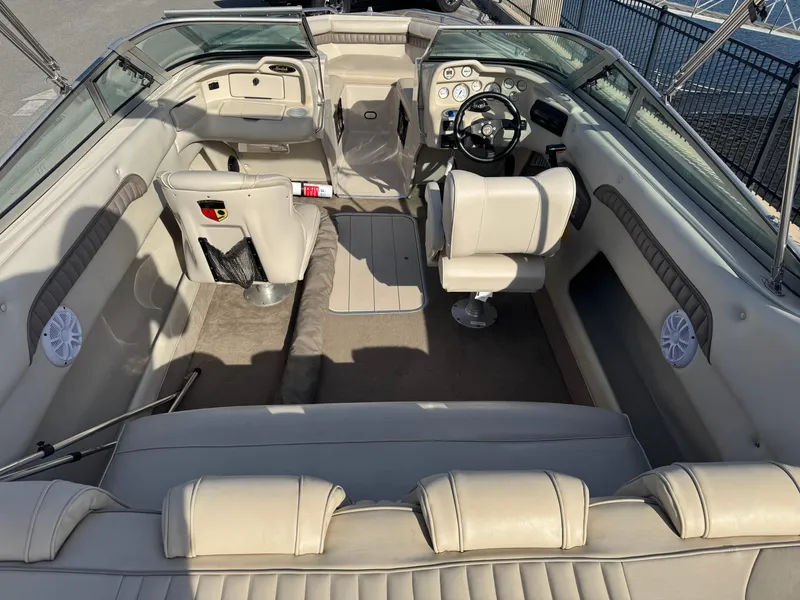 Slide: The Image of 1998 Mariah 222 Shabah boat interior with beige seating and steering wheel. - 5