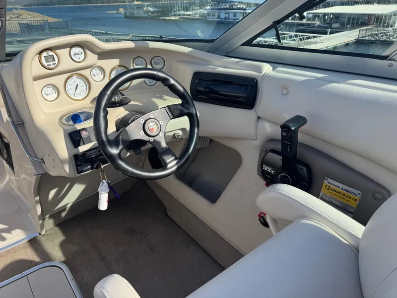 Slide: The Image of Interior of 1998 Mariah 222 Shabah boat with steering wheel and dashboard controls. - 8