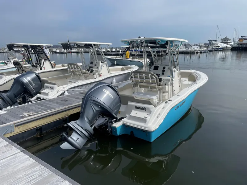 Slide: The Image of 2023 Key West 219 FS boat docked with Yamaha outboard motor. - 2