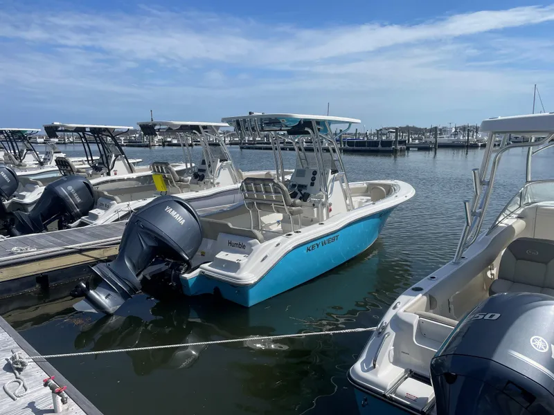 Slide: The Image of 2023 Key West 219 FS boat docked with Yamaha outboard motor. - 3