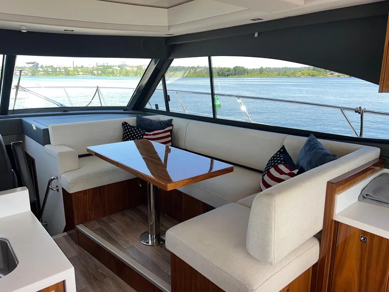 Slide: The Image of Luxurious interior of 2023 Riviera 4600 Sport Yacht with elegant seating and scenic water view. - 11