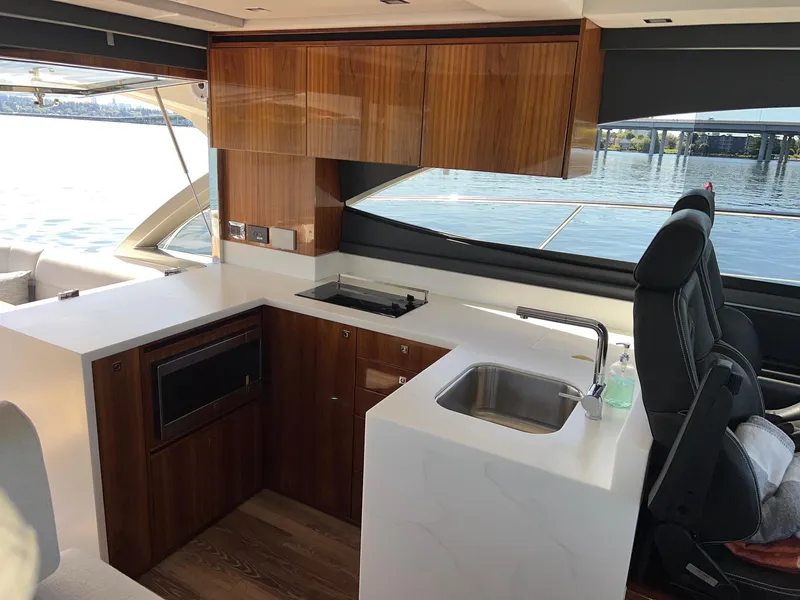 Slide: The Image of Interior of 2023 Riviera 4600 Sport Yacht Platinum Edition with modern kitchen design. - 13