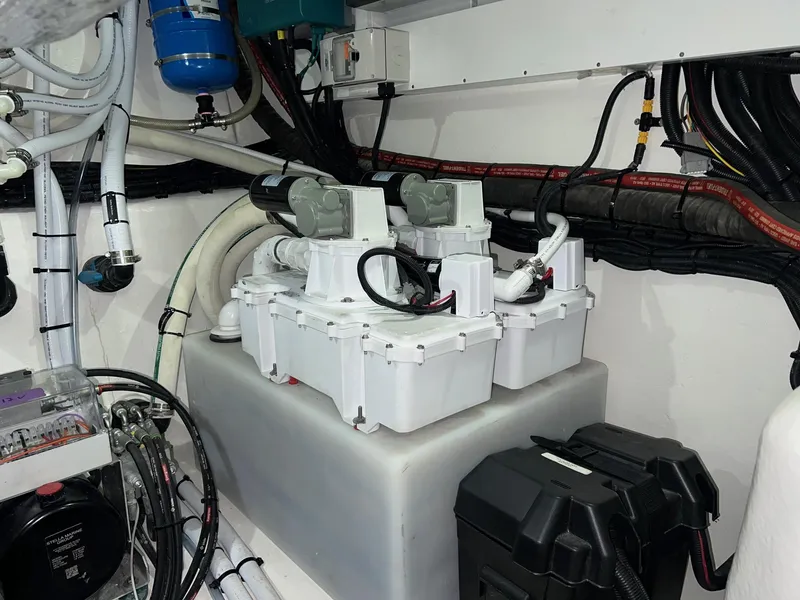 Slide: The Image of Engine room of 2023 Riviera 4600 Sport Yacht Platinum Edition with electrical components and wiring. - 23