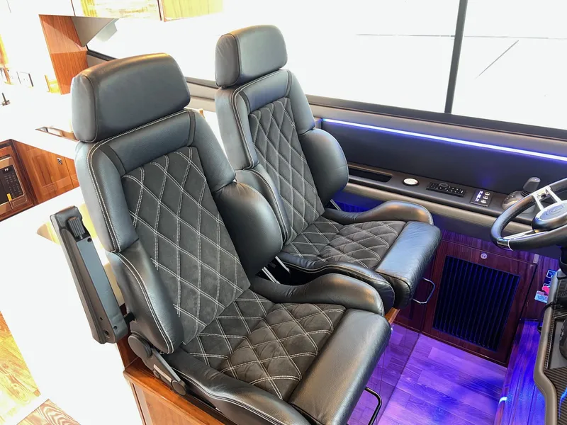 Slide: The Image of Luxurious black leather seats in 2023 Riviera 4600 Sport Yacht Platinum Edition cockpit. - 7