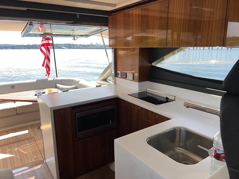 Slide: The Image of Luxurious interior of 2023 Riviera 4600 Sport Yacht Platinum Edition with modern kitchen amenities. - 9