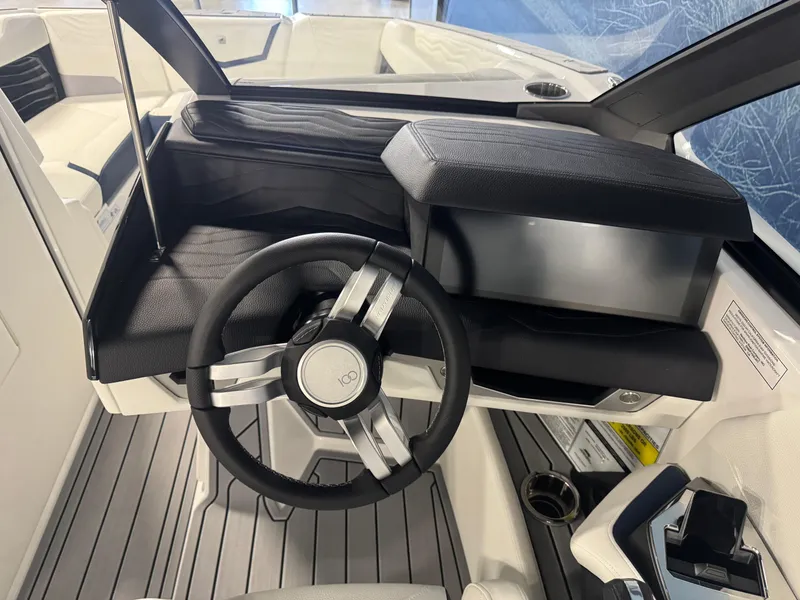 Slide: The Image of 2025 Nautique Super Air Nautique G23 helm with sleek steering wheel and modern dashboard. - 11