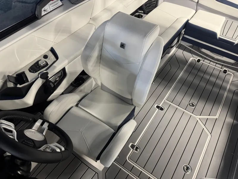 Slide: The Image of 2025 Nautique Super Air Nautique G23 interior with sleek seating and modern controls. - 13