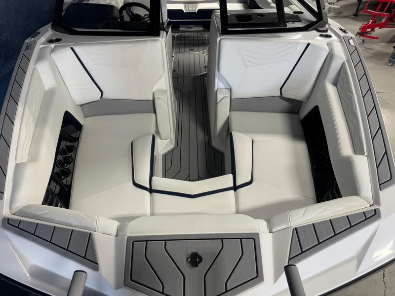 Slide: The Image of 2025 Nautique Super Air Nautique G23 boat interior with sleek white seating and modern design. - 15