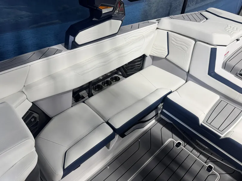 Slide: The Image of 2025 Nautique Super Air Nautique G23 interior with white seating and modern design. - 7