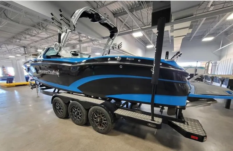 Slide: The Image of 2018 MasterCraft X26 boat on trailer in indoor showroom. - 3