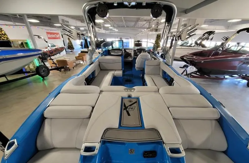 Slide: The Image of 2018 MasterCraft X26 boat interior with luxurious seating in a showroom. - 5