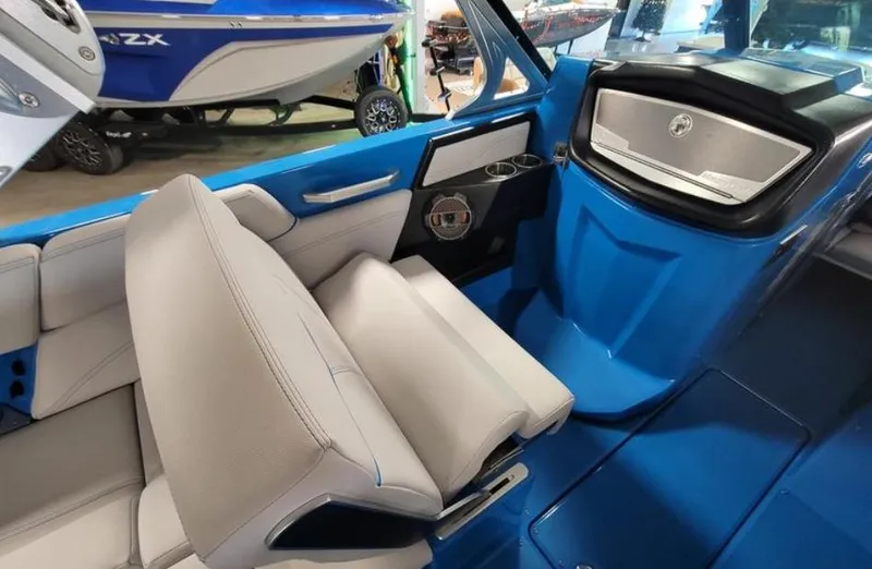 Slide: The Image of 2018 MasterCraft X26 boat interior with blue and white seating and dashboard. - 6