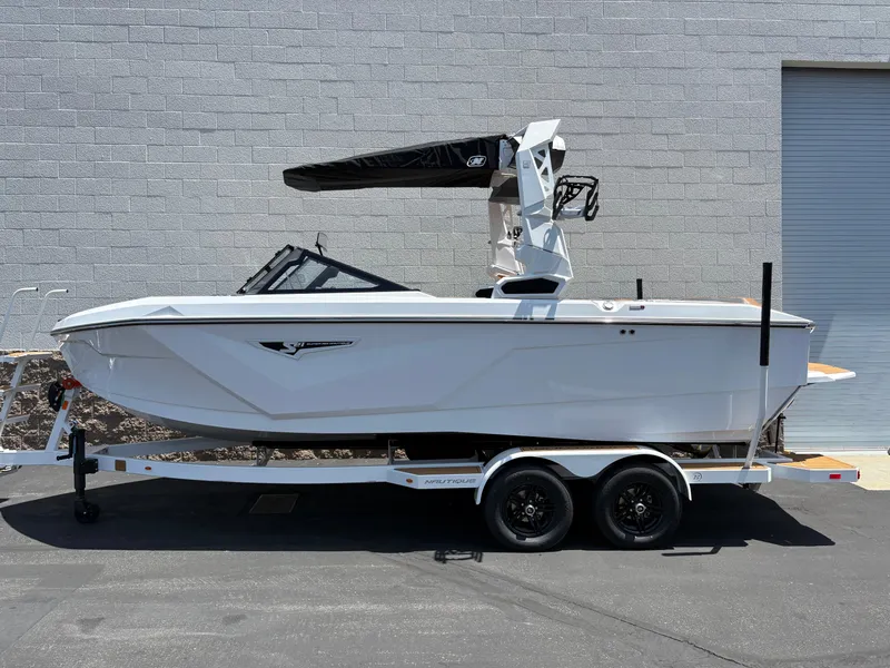 The Image of 2025 Nautique Super Air Nautique S21 boat on trailer, parked outdoors. - 0