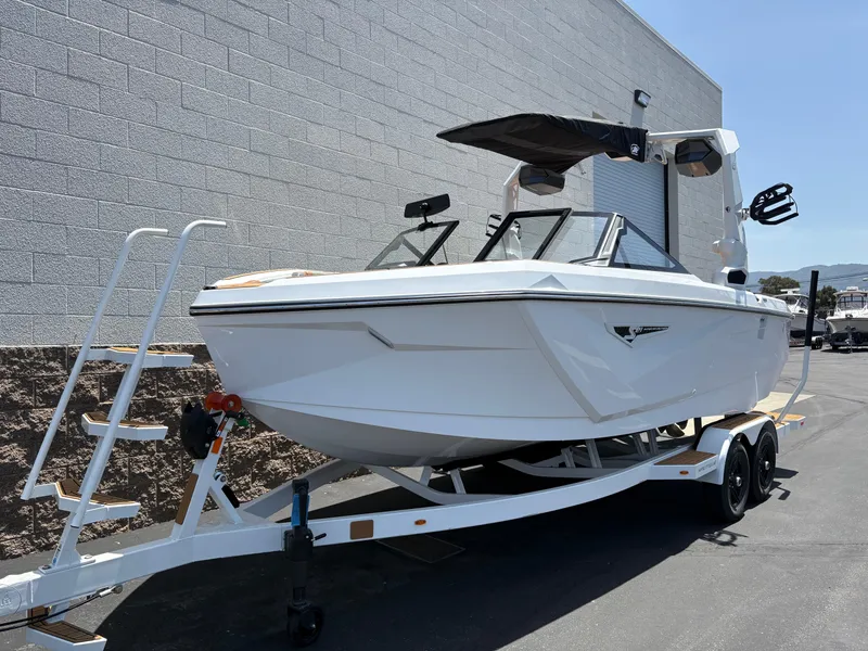 Slide: The Image of 2025 Nautique Super Air Nautique S21 boat on trailer, parked outdoors. - 1