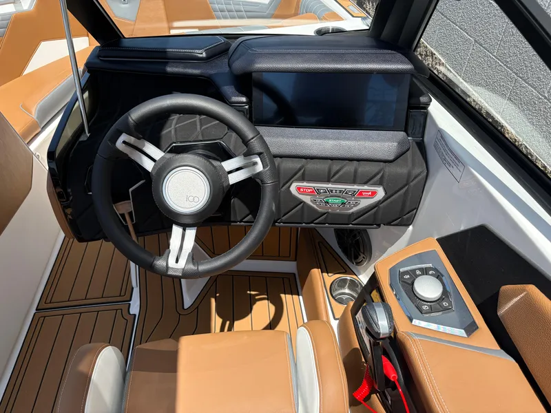 Slide: The Image of 2025 Nautique Super Air Nautique S21 cockpit with modern steering and control panel. - 10