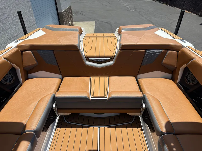 Slide: The Image of 2025 Nautique Super Air Nautique S21 interior with tan seating and sleek design. - 5