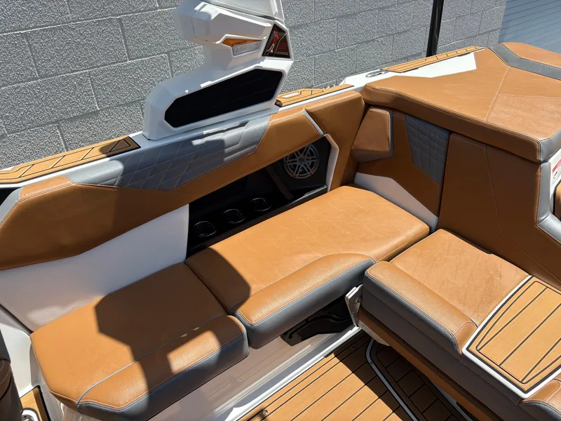 Slide: The Image of 2025 Nautique Super Air Nautique S21 interior with tan and gray seating, modern design. - 6