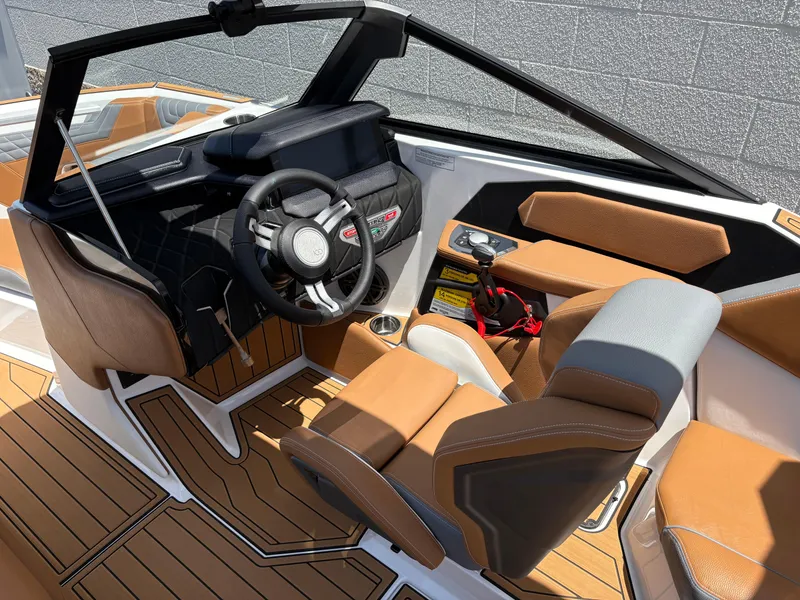 Slide: The Image of Interior of 2025 Nautique Super Air Nautique S21 boat with modern steering and seating. - 9